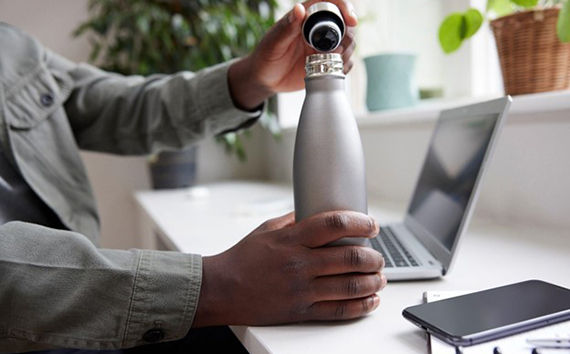 Man Holds Reusable Water Bottle